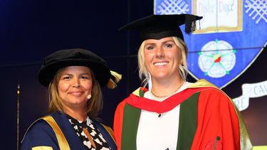 Professional footballer, Millie Bright, accepts her honorary degree from Pro-Chancellor, Claire Brownlie