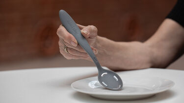 A hand holding the Tasty Spoon.