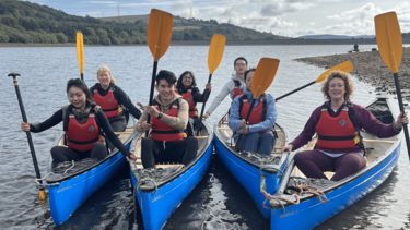 MBA students and staff in canoes.