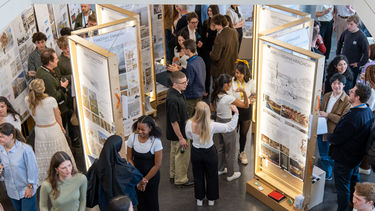 Photo from above of students mingling at 2024 summer exhibition