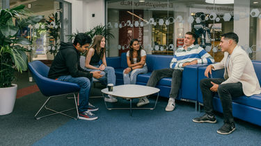 A group of students sat on the sofas.