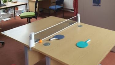 Room with two desks and a table tennis table