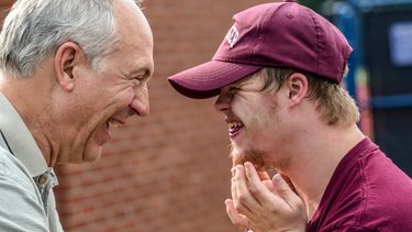 Two men laughing together