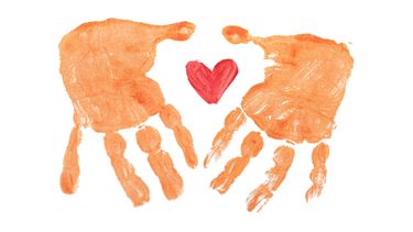 A heart within two handprints