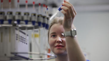 A student holding up a syringe