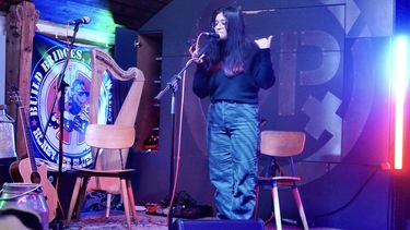 A student musician on stage singing