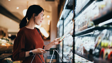 Women in supermarket looking at packaging