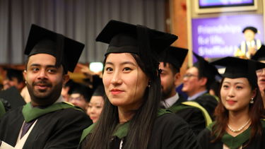 Happy graduates in the hall clapping