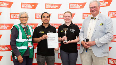 Two students from Sheffield being presented with the winning trophy