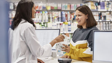 A Pharmacist talking to a member of the public