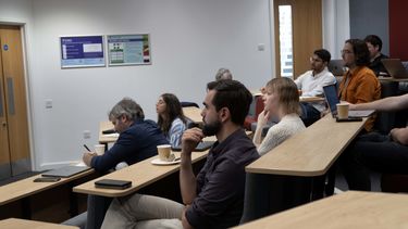 conference attendees listening to Andrea Genovese