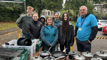 A group of students and staff ready to give out kitchenware at the Free Shop