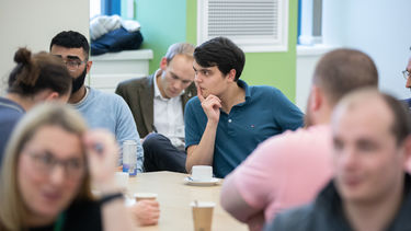 Students sitting around a table discussing