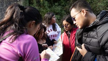 MBA students and MBA Programme Director Sabrina Thornton plan their scavenger hunt route