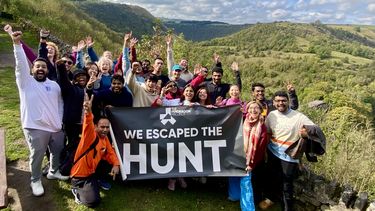 MBA Cohort celebrating completing the 'Hunted' mission as part of their outdoor activity day