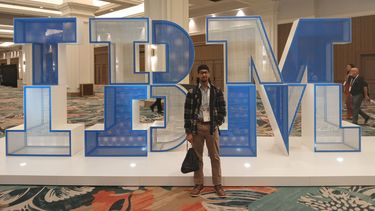 second year computer science student, Shohail Ismail, infront of a big IBM sign