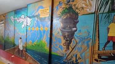 A mural depicting a colourful scene seen from a boat