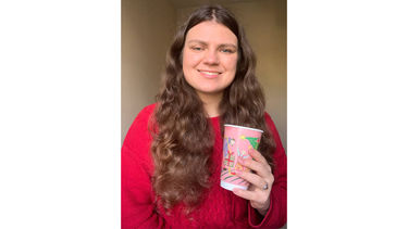 Student Alisa shows off Christmas hot drinks cup design