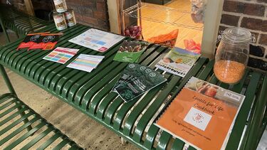 Leaflets, jar of lentils and 'Lentils for Life' cookbook lying flat on a bench