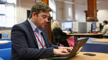 Filip Leonard working on a laptop.