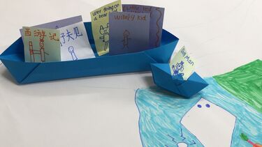 Origami boats holding messages in multi languages