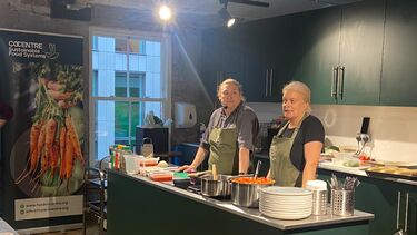 Two people leading cooking class