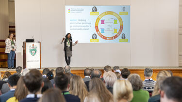 Professor Anwesha Sarkar presenting on stage at the NAPIC launch event
