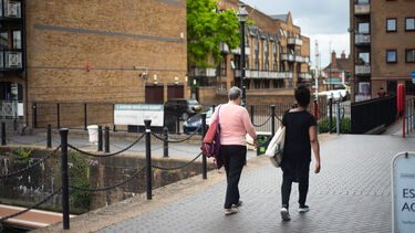 women walking outside by the canal