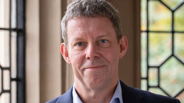 Vice-Chancellor Koen Lamberts stood in front of windows in Firth Court