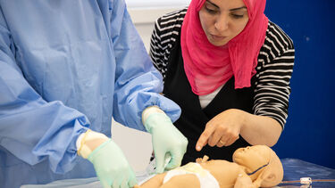 University of Sheffield health student measuring a model of a new born baby
