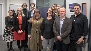 Team members stand with members of Sheffield City Council