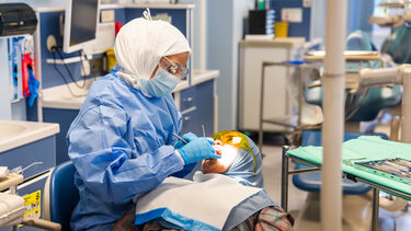 Periodontics student working on a simulated patient