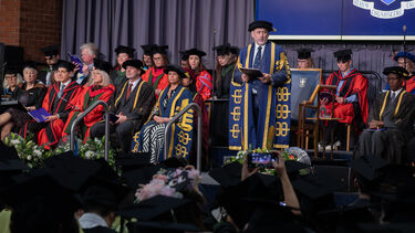 Image of staff procession on stage