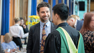 Jonny Crawley speaking to a prize winner.