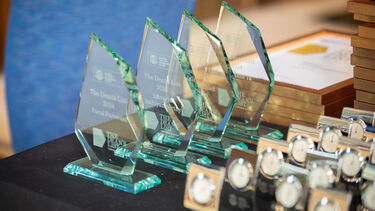 Dean's List trophies lined up on a table.