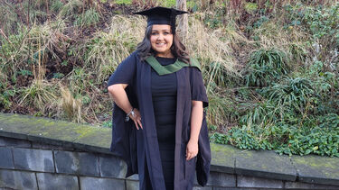 Claire at her graduation in Sheffield. She wears a graduation cap and gown.
