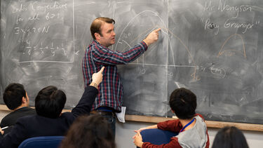Lecturer teaching a maths class