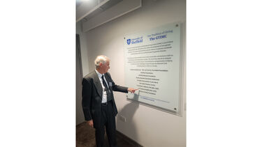 Tom’s stepson, John Maun, with his stepfather’s plaque in the GTIMC.