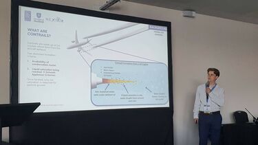 Aerospace student stood in front of a large screen presenting his research