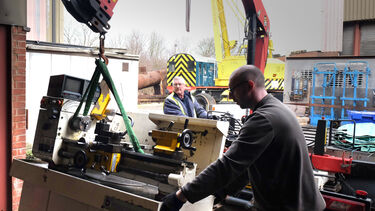 Lifting the lathe donated to the Midland Railway from a truck with a crane