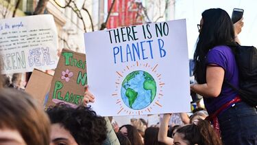 Climate activist holding a 'there is no planet B' sign