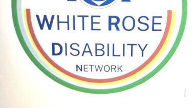 The logo for White Rose Disability Network written into a multicoloured circle