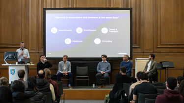 Image of group of people presenting on a screen in Mappin Hall 