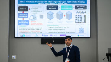 PhD Candidate presenting their work on a projection screen