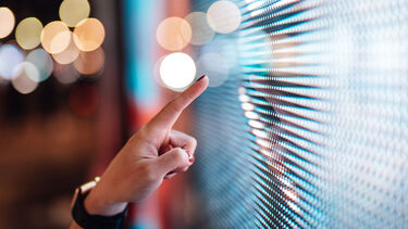 Woman pointing to a digital screen