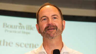 Prof Hugh Ellis speaking into a microphone