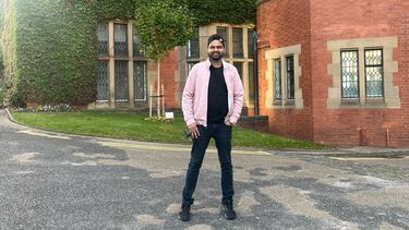 Man standing in front of red brick building on sheffield campus