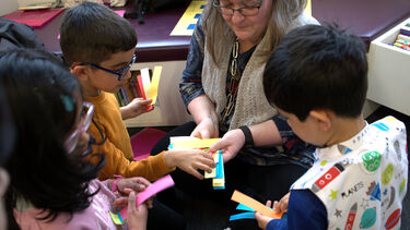 Dr Sabine Little hosting reading activities with school children.