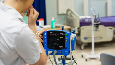 Medical student looking at a heart monitor