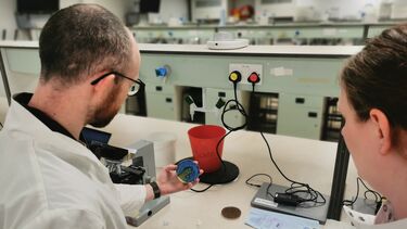 Two scientists examining a biological sample.